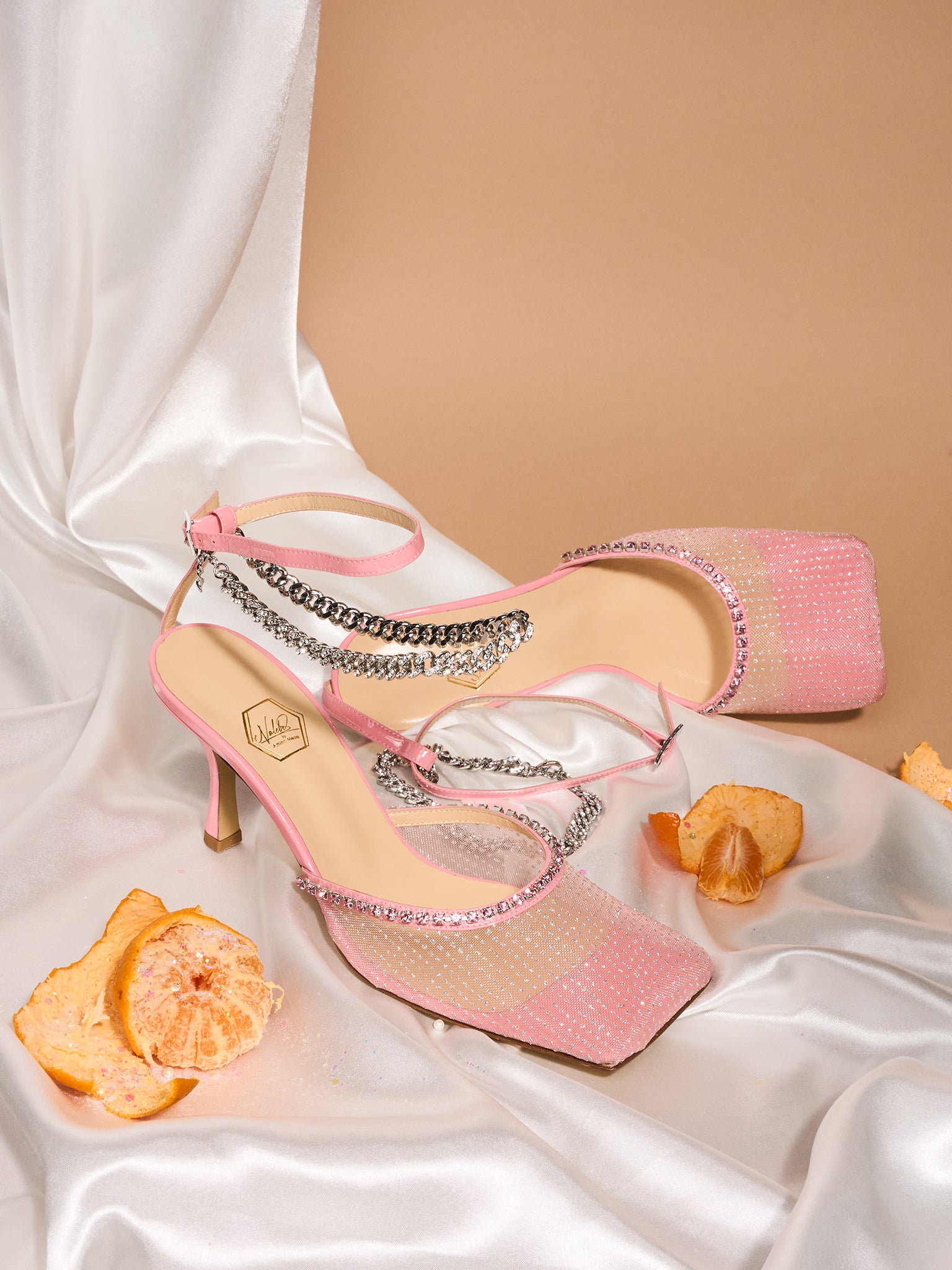 Pink high-heeled shoes with chain details