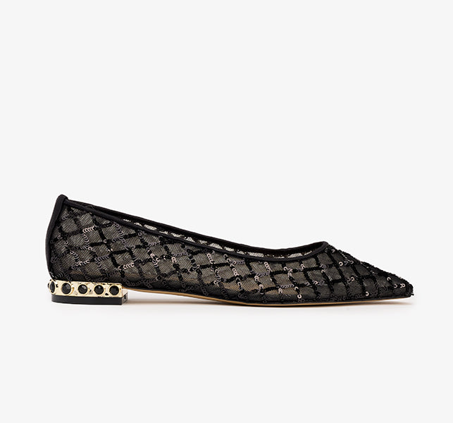 A black flat shoe with a mesh upper and a square toe, featuring a small embellished heel.